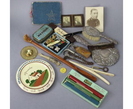 A child’s silver-backed hair brush; a silver-backed hand mirror; a Stratton compact; a pair of glove stretchers, etc.