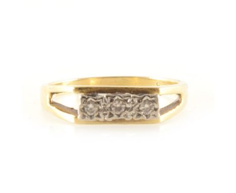 A 1970s diamond three stone ring, three brilliant cut diamonds illusion set in an 18 carat yellow and white gold mount with a