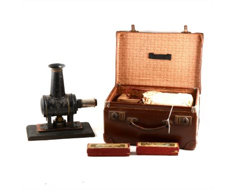 Toy magic lantern, with original burner and two boxes of slides; a larger lantern and a case of slides