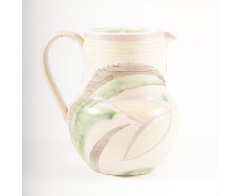 A Studio Ware jug by Susie Cooper, 1932, the ribbed body painted with stylised leaves, in green, light mauve and cream tones,