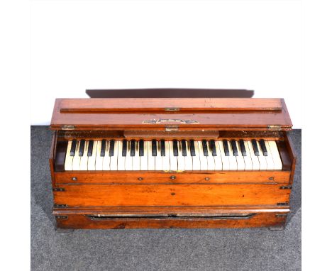 A walnut and brass banded folding harmonium / ship's piano, retailed by the Sunday School Union, Ludgate Hill, London, with f