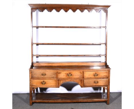 A joined oak dresser, some alteration, three shelf delft rack, base with five drawers over a pot board, width 160cm, height 2