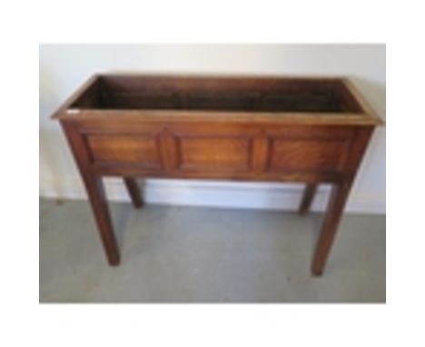 An oak planter with three panel front, 72cm tall x 95cm x 34cm 