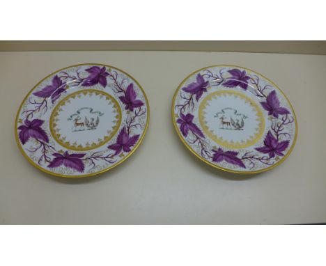 A pair of 19th century Worcester Flight Barr abd Barr Armorial plates. Each decorated with a central crest surrounded by vine