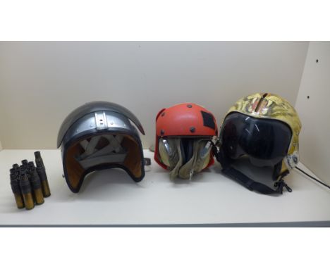 A Gentex flying helmet with Tiger decoration, a flight desk crew helmet and earphones and a regular MKIA helmet and some shel