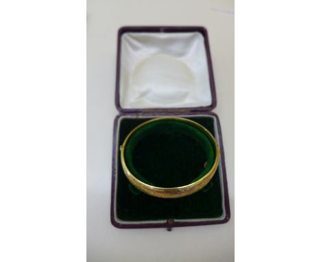 A 9ct yellow gold hallmarked hinged bangle approx 12.6gs, 6 x 6.5cm with box. Minor dents but generally good 