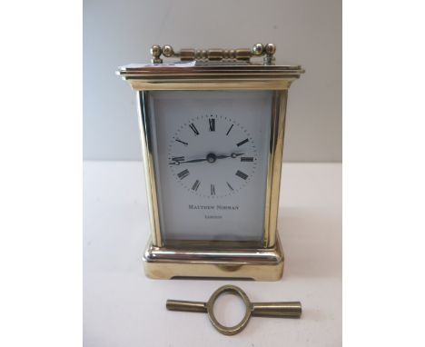 A brass Matthew Norman carriage clock, running in generally good condition. 12cm tall. 