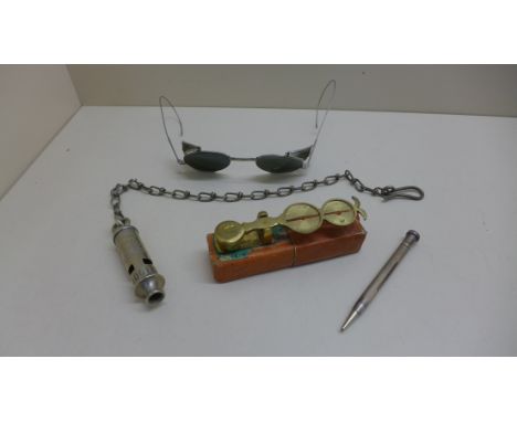 A pair of vintage driving glasses, a metropolitan police whistle no 40610, a propelling pencil and a set of sovereign scales.