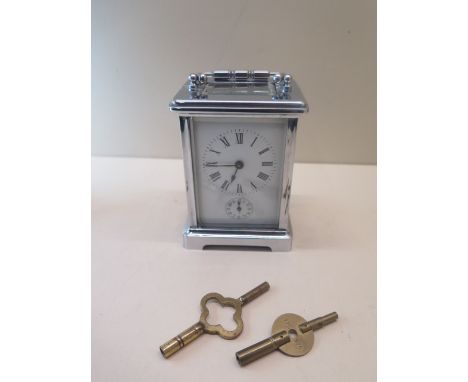 A chromium plated carriage alarm clock striking on a bell 12cm tall - generally good condition, running. 