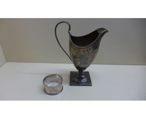 A silver helmet shaped cream jug and a silver serviette ring total weight approx. 4.6 troy oz, including wooden base to jug. 