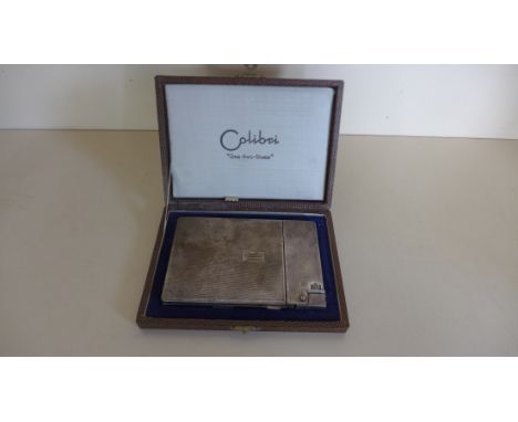 A colibri silver-plated one-two-three cigarette case lighter boxed with instructions. Mechanism working, one catch loose to s
