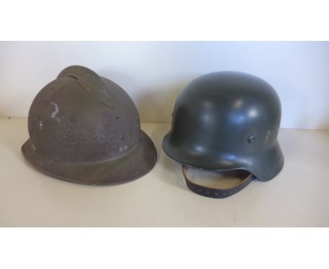 A WWII French helmet missing badge and a post war German helmet 