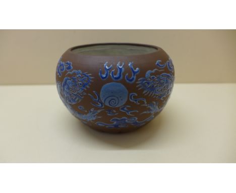 A Chinese Yixing fluted bowl decorated in blue enamel of dragons chasing a pearl - 8cm x 12cm - small hairline inside bowl ot