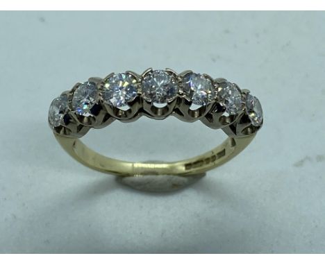 An impressive 9ct diamond ring set with seven stones, round brilliant cut, totaling just under 1ct each, stone approx 0.13cts