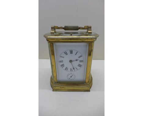 A French brass carriage clock striking on gong with repeat and alarm.15cm tall, 12cm wide with key.In running order, some cra