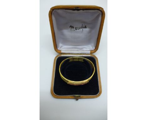 A yellow gold ruby and pearl hinged bangle, no hallmarks but tests to approx. 18ct, weight approx 24.5gs, 6.8x6cm, generally 