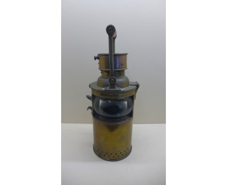 A brass signalling lamp - Height 22cm stamped E.G &amp; S 1918 