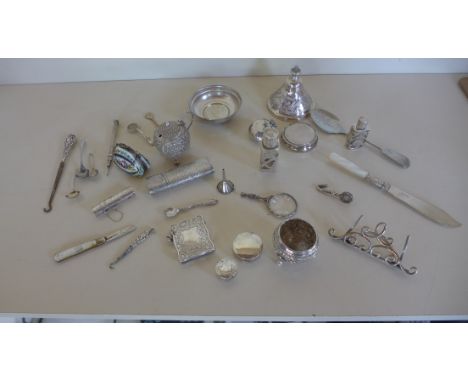 A silver menu stand, snake spoon, a silver salt, silver vesta case, two silver pill boxes and assorted white metal and plated