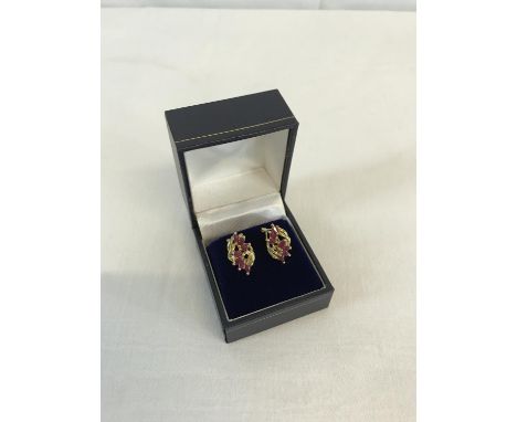 A pair of 14ct gold ladies earrings with ruby & diamond setting 