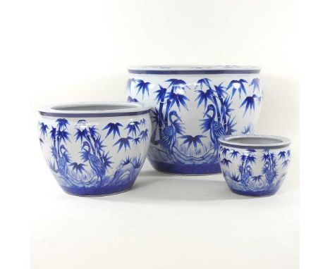 A graduated set of three modern Chinese blue and white porcelain fish bowls, decorated with bamboo, largest 36cm diameter (3)