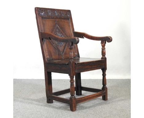 A 17th century and later oak wainscot chair, with a lozenge carved panelled back and plank seat on turned legs, united by squ