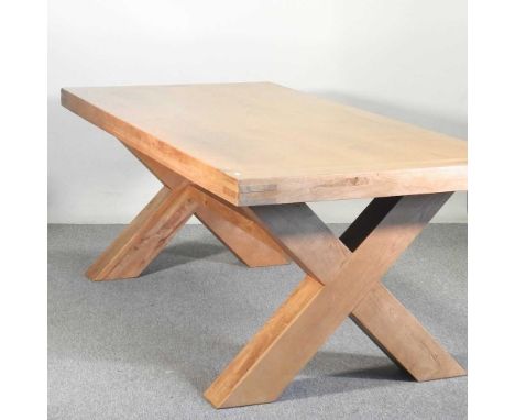A modern light oak dining table, on an x-frame base220w x 100d x 83h cm