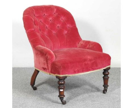 A Victorian red button back upholstered armchair, on turned legs