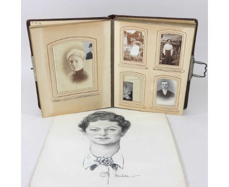 An early 20th century photograph album, together with a pastel portrait, of a lady, unframed (2)