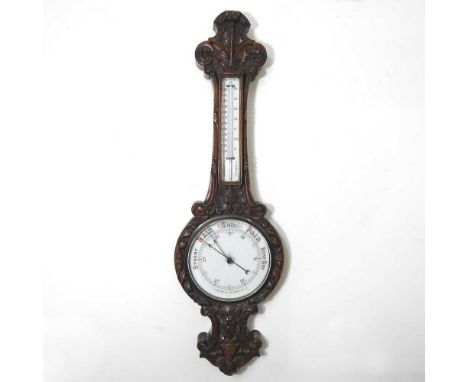 A large Victorian carved oak cased aneroid barometer, decorated with scrolls and flowers, 113cm highOverall condition is comp