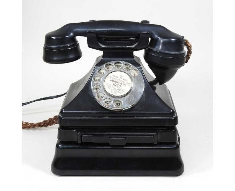 A vintage black bakelite GPO telephone, on stand, 22cm high