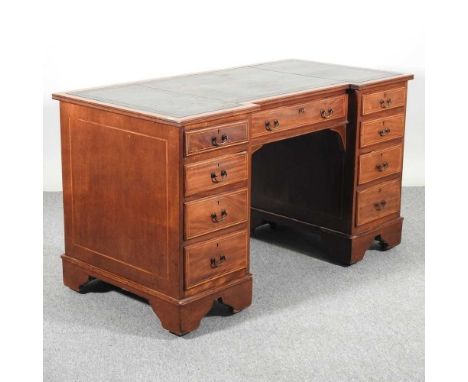 An Edwardian mahogany and satinwood crossbanded inverted breakfront pedestal desk, with an inset leather top138w x 68d x 78h 