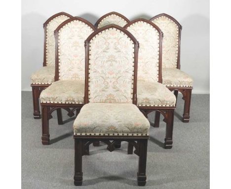 A set of six 19th century walnut Gothic revival dining chairs, with upholstered backs and seats, on tracery moulded legs (6)O