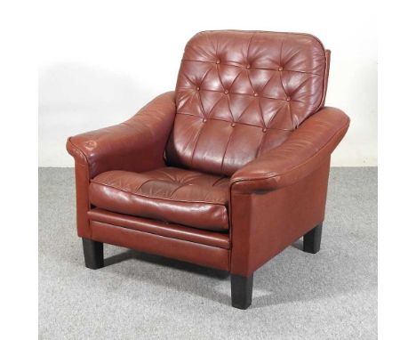 A mid 20th century Danish brown upholstered button back armchair