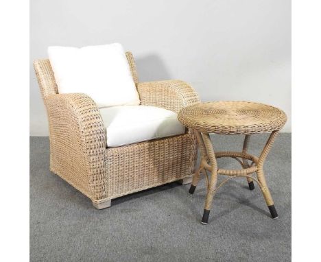 A wicker armchair, with cream cushions, together with a circular wicker occasional table, 55cm diameter (2)Overall condition 