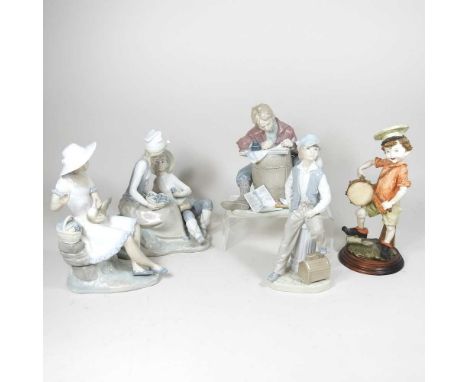 A Lladro figure of a boy and his dog, 21cm high, together with four various Nao figures and another (6)