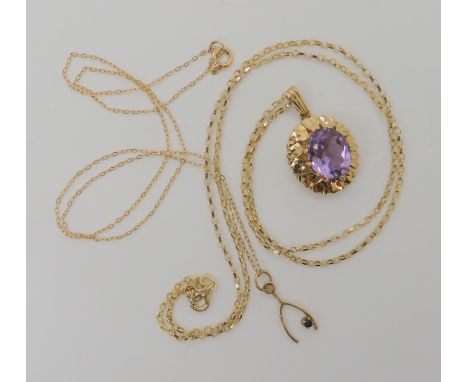 A 9ct gold amethyst set pendant and chain length 50cm, and a sapphire set wishbone pendant and chain length 40cm, weight comb