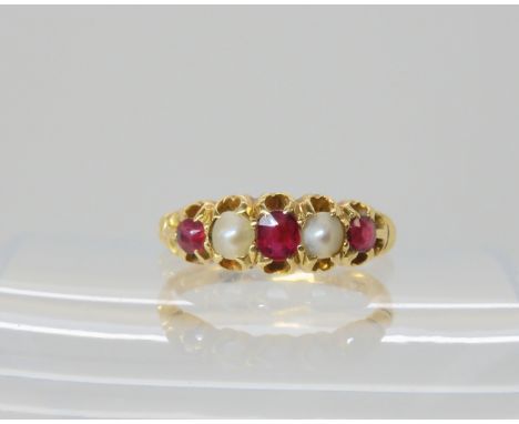 An 18ct gold ruby and pearl set ring, size M1/2, weight 3.3gms Condition Report: Available upon request