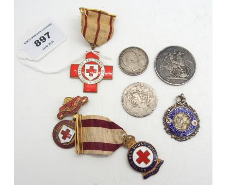 A lot comprising a St Andrews Ambulance Association silver and enamel medal, three red cross medals and three pre 1947 GB coi