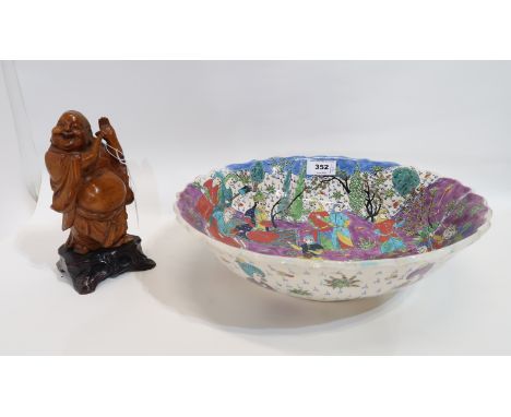 An Arabic ceramic bowl with colourful decoration and a carved wooden buddha Condition Report: bowl badly broken and re stuck.