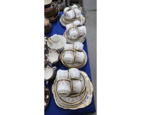 A Phoenix China teaset with Greek key pattern and printed swag decoration, comprising sixteen cups, saucers, plates, two cake