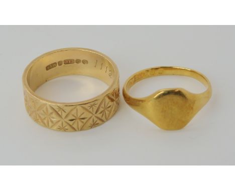 An 18ct gold signet ring dated London 1929, size K, weight 2.7gms, and a retro 1970's wide engraved wedding ring size N weigh