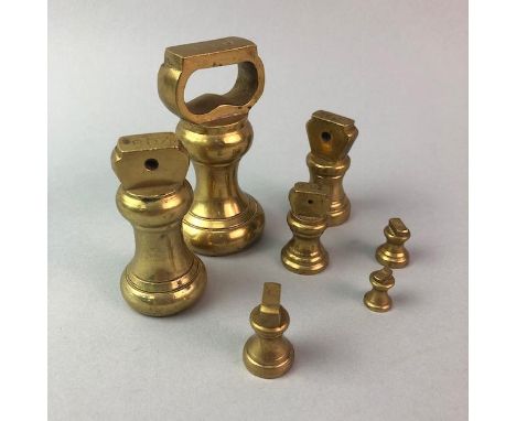 SET OF BRASS IMPERIAL WEIGHTS, along with a pair of brass candlesticks, a spirit level, a naval compass and another compass