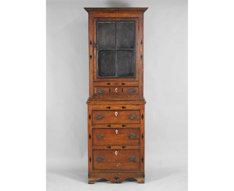 A 19th century oak slender cabinet on chest, North Wales, the ogee cornice over four pane glazed door opening to reveal a sin