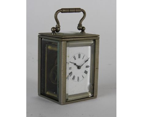 An early 20th century miniature carriage timepiece the 1.25 inch rectangular enamel dial with ring of Roman numerals in a pla
