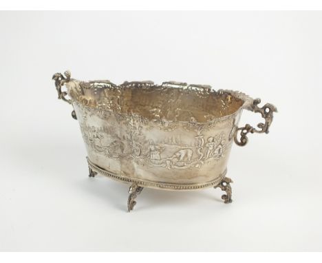 A Dutch silver two handled bowl, of oval form with embossed figural scenes to the body, raised on four bracket feet, 18.5cm w