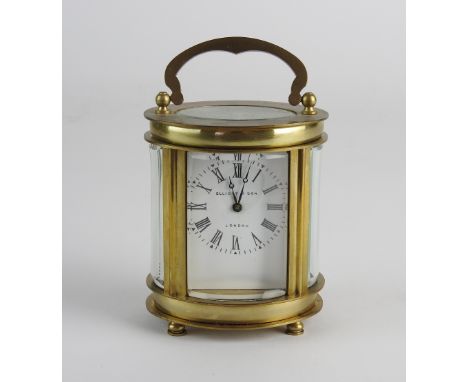 A 20th century Elliot & Son retailed oval carriage timepiece, the 1.5 inch white enamel dial signed 'Elliot & Son, London', w