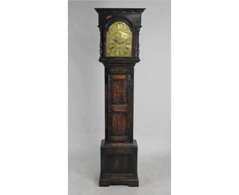 An early 20th century eight day chiming longcase clock the 12.25 inch arched brass dial with label for Potts & Sons Leeds and