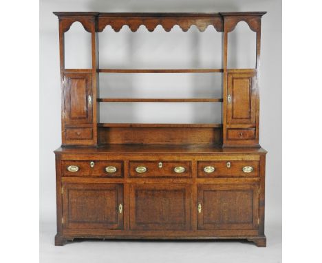 A George III oak Shropshire style high dresser with open three shelf rack flanked by a single crossbanded cabinet to each sid