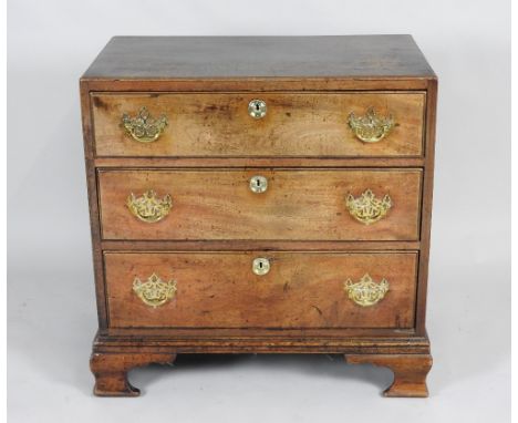 A George III mahogany chest of three long graduated drawers the rectangular flush fitting top with moulded edge the drawers w