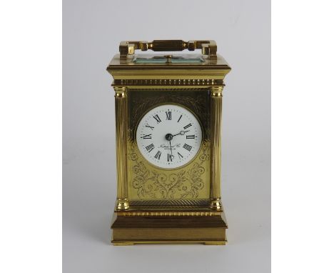 A 20th century gilt brass repeating carriage clock retailed by Nathan & Co Birmingham with 2.25 inch diameter white enameled 